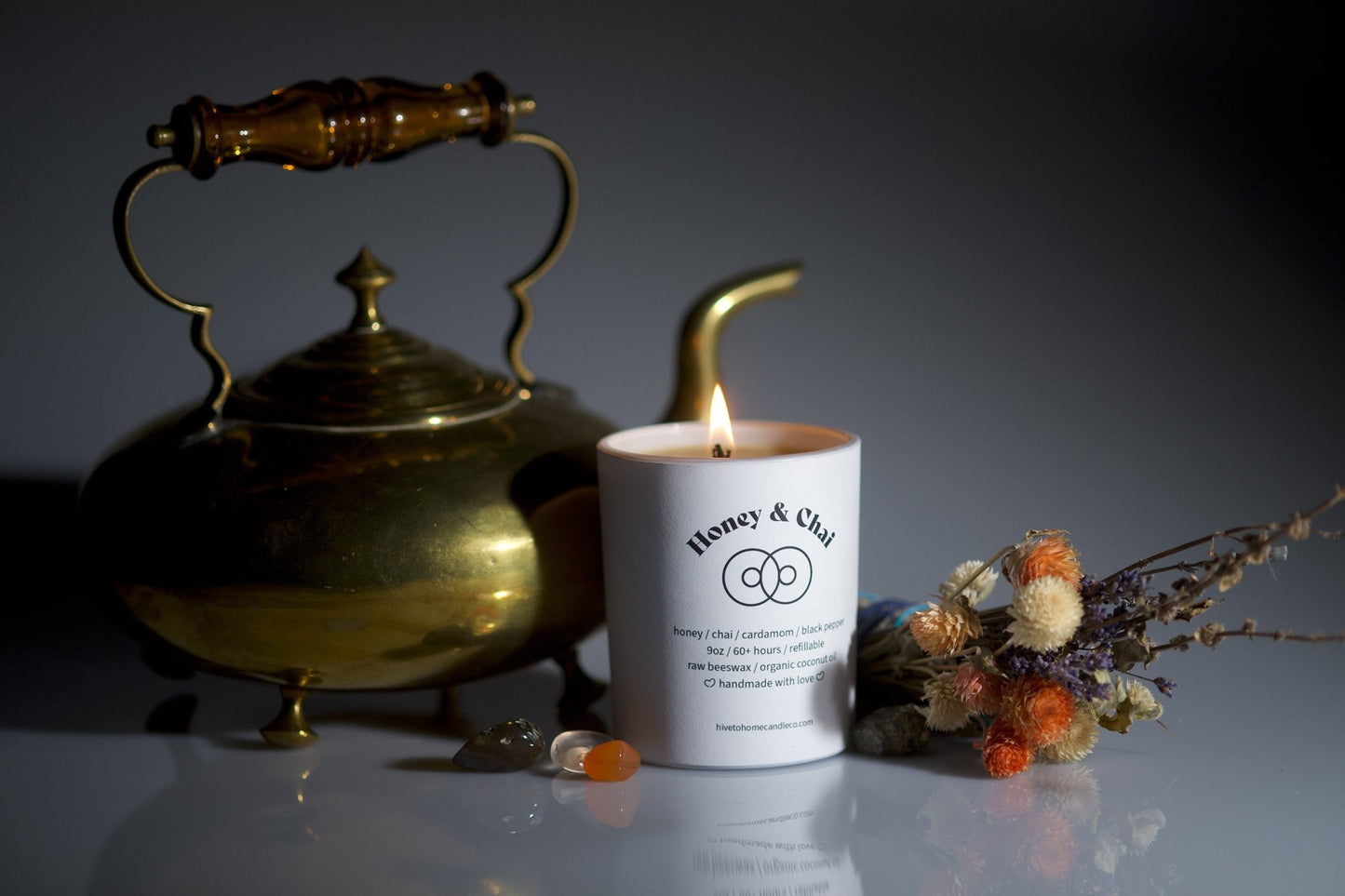 Burning beeswax candle, antique decorative pot, fresh flowers and lavender