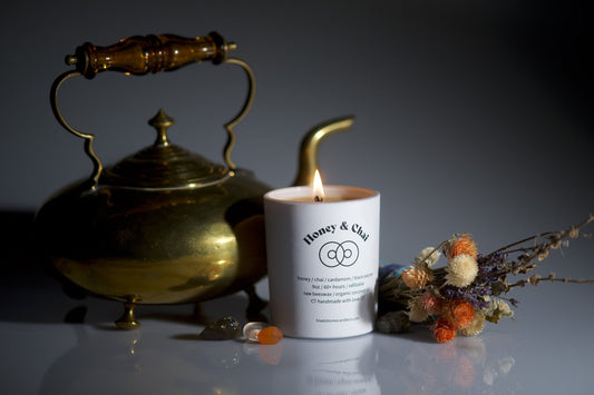 Burning beeswax candle, antique decorative pot, fresh flowers and lavender