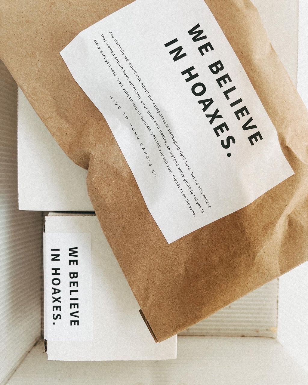 Sustainable beeswax candles being shipped in recyclable packaging.