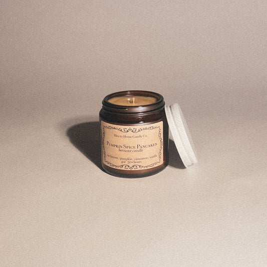 4 oz pumpkin spice pancake fall scented candle with white lid leaning on amber jar.