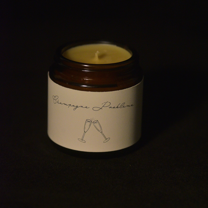 Unlit scented beeswax candle. Champagne problems. 4 oz amber glass jar.