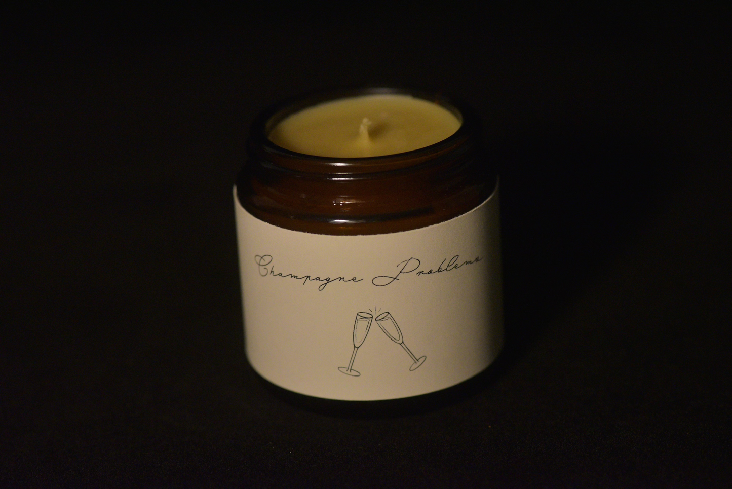 Unlit scented beeswax candle with black backround