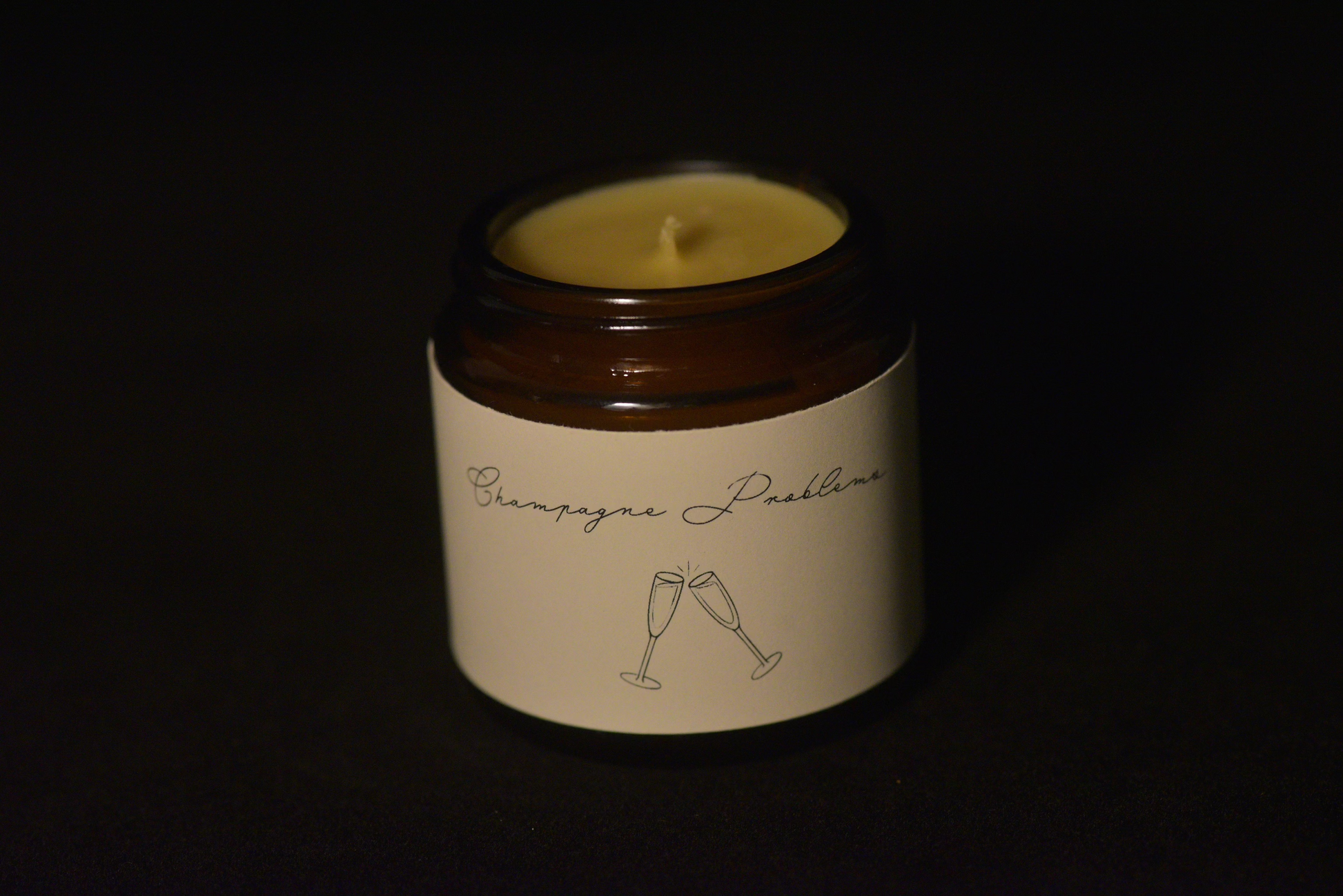 Unlit scented beeswax candle with black backround