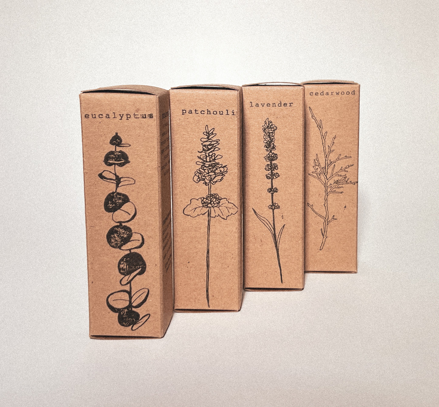 botanical illustrations of eucalyptus, patchouli, lavender, & cedar wood hand-stamped with carbon negative algae ink onto cardboard packaging.