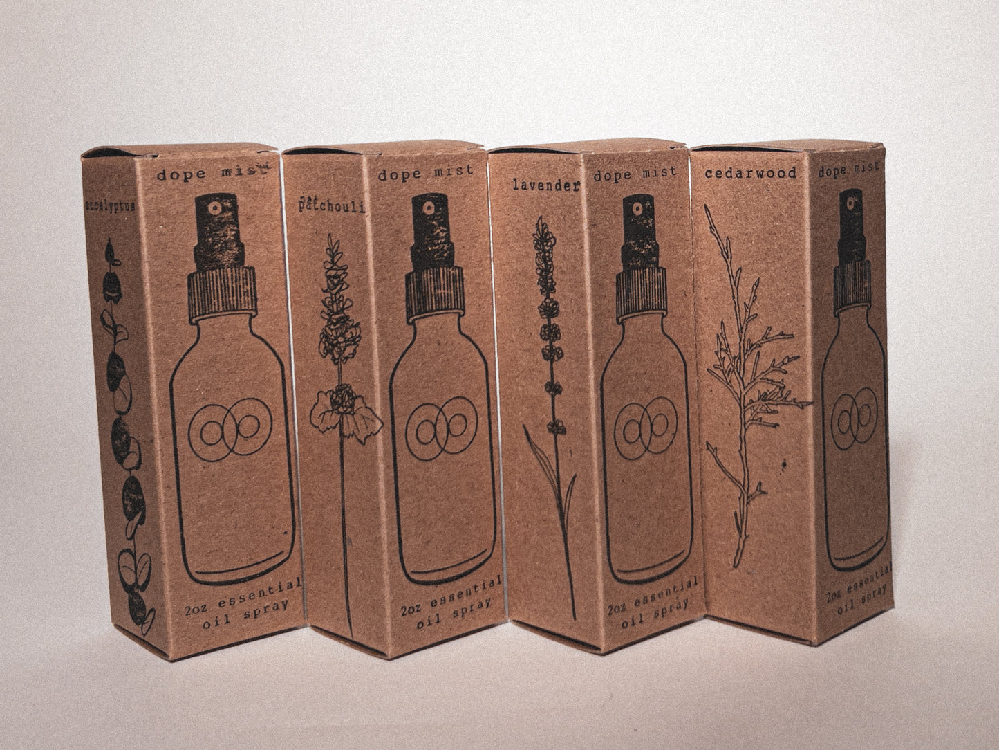 Collection of Essential Oil Sprays stamped onto boxes with a stamped drawing of each scent. Product packaging image.