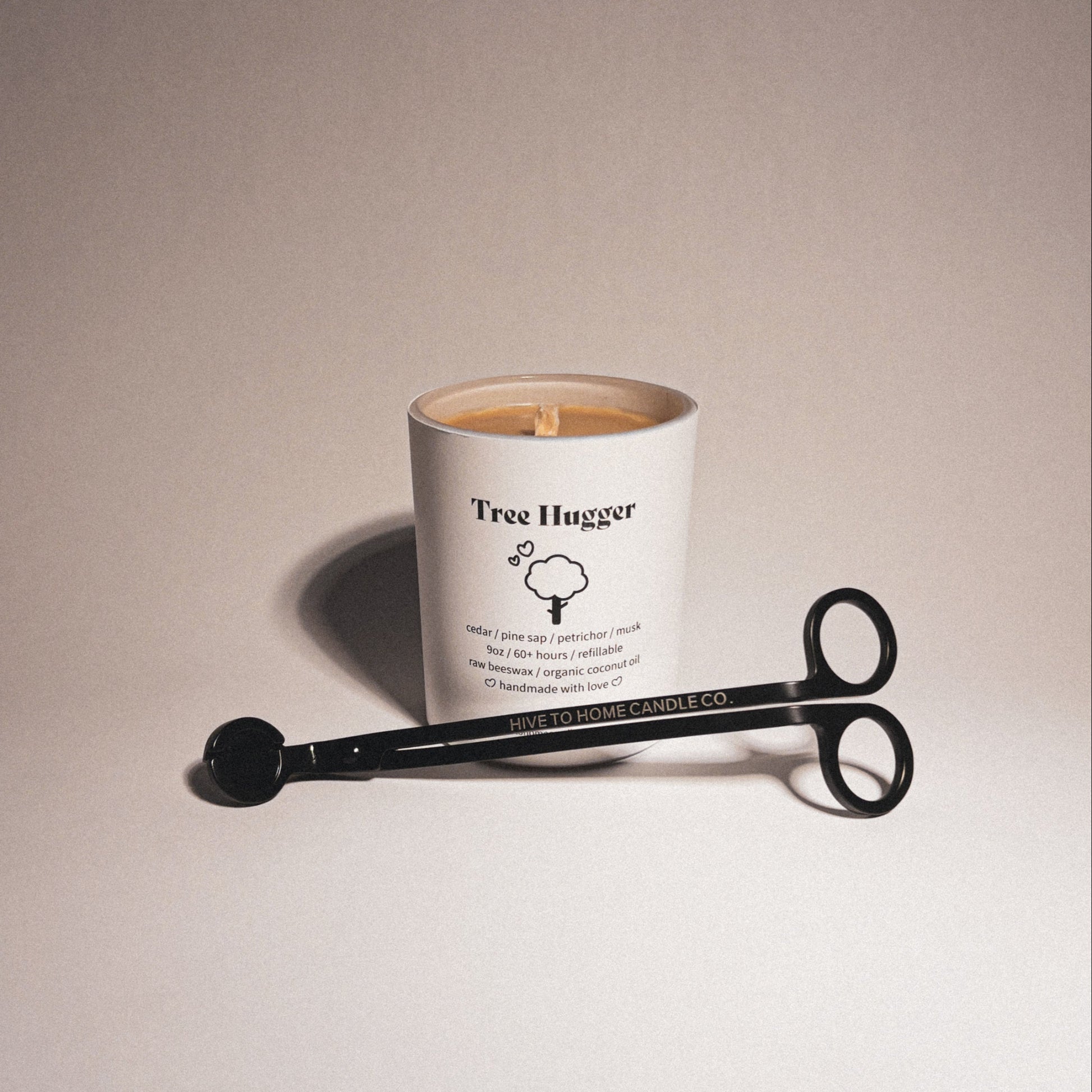 Cedar and pine scented beeswax candle with laser engraved candle wick trimmer.