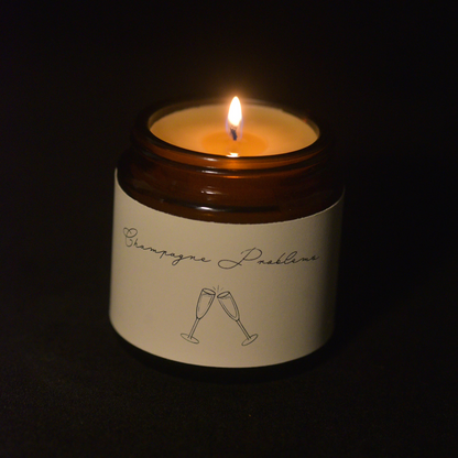 toasting champagne scented candle 4 oz amber scented beeswax burning image